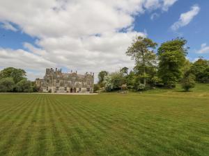 a large grass field in front of a castle at Sika in Dorchester