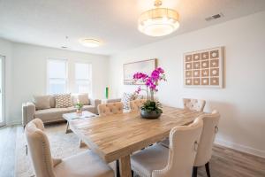 a dining room with a wooden table and chairs at Villa Capriani 218B Oceanfront with Pool at North Topsail Beach in Chadwick Acres