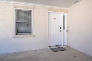 an empty room with a white door and a window at Villa Capriani 218B Oceanfront with Pool at North Topsail Beach in Chadwick Acres