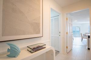 a living room with a table and a picture on the wall at Villa Capriani 218B Oceanfront with Pool at North Topsail Beach in Chadwick Acres +29 photos