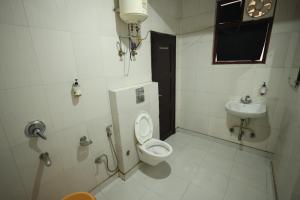 a bathroom with a toilet and a sink at The Paramant Near Delhi IGI Airport in New Delhi