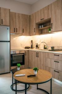 a kitchen with wooden cabinets and a table in it at Euphoria Loft in Karfas +17 photos