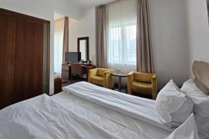 Postel nebo postele na pokoji v ubytování Iaki Conference & Spa Hotel