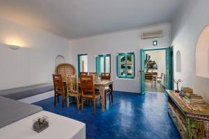 a living room with a table and chairs at Nissia Beach Apartments & Suites in Kamari