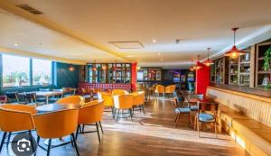 a restaurant with tables and chairs in a room at Biggerstaffs retreat in Lossiemouth