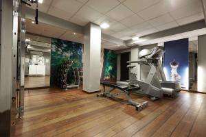 a room with a gym with a treadmill at Scandic The Mayor in Aarhus +42 photos