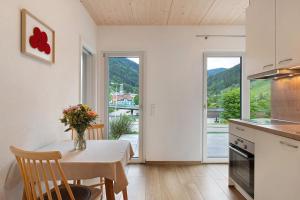 a kitchen with a table with a vase of flowers on it at Wanderlust in Todtnau
