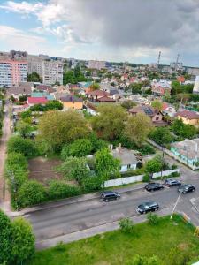 a city with cars parked in a parking lot at Вишенка in Vinnytsya