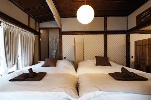 two beds in a room with towels on them at Traditional Japanese House in Wada +80 photos