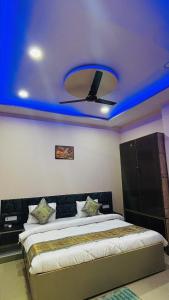 a bedroom with a bed with a blue ceiling at Spiritual Homestay in Varanasi