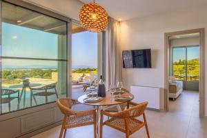 a dining room with a table and chairs and a balcony at Casa Tierra - Villa II in Kos