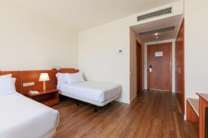 Posteľ alebo postele v izbe v ubytovaní Sercotel Arrahona Sabadell