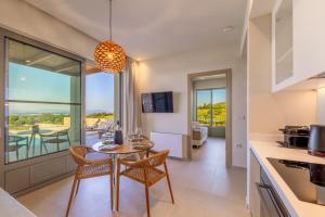 a kitchen and dining room with a table and chairs at Casa Tierra - Villa II in Kos