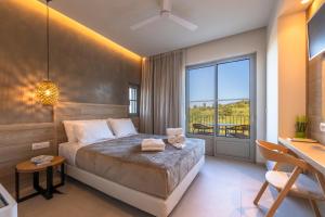 a bedroom with a bed and a large window at Casa Tierra - Villa II in Kos +17 photos