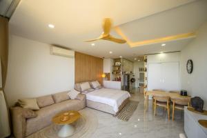 a bedroom with a bed and a couch and a table at Beach Studio in Ấp Phú Tịnh (2) +12 photos