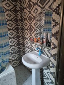 a bathroom with a white sink and a shower at Luxury & Secured 3 Bedroom House with 24 Hours Solar Light in Ikorodu