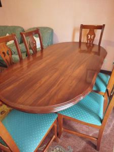 a wooden table with four chairs around it at Apartamento El Llerau Cangas de Onis in Cangas de Onís