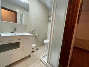 a bathroom with a sink and a toilet at Apartamento El Llerau Cangas de Onis in Cangas de Onís