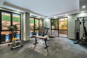 a gym with treadmills and ellipticals in a room with windows at Retro 2 in Alanya