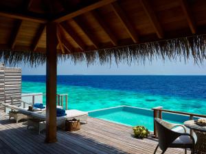 a resort deck with a swimming pool and the ocean at Dusit Thani Maldives - 50 percent off on Transfers for Stays of 5 Nights stay until 20 December 2026 in Baa Atoll