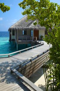 a house on a dock in the water at Dusit Thani Maldives - 50 percent off on Transfers for Stays of 5 Nights stay until 20 December 2026 in Baa Atoll