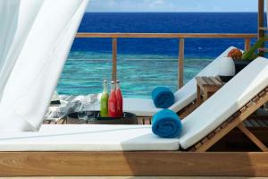 a balcony on a cruise ship with a view of the ocean at Dusit Thani Maldives - 50 percent off on Transfers for Stays of 5 Nights stay until 20 December 2026 in Baa Atoll