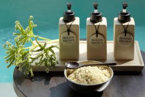 a group of four bottles of protein absorption liquids and a bowl of rice at Dusit Thani Maldives - 50 percent off on Transfers for Stays of 5 Nights stay until 20 December 2026 in Baa Atoll +164 photos