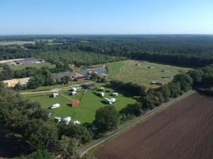 an aerial view of a farm with tents and a field at Hoeve Twente - De Bosuil in Heythuysen
