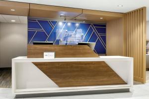 an office lobby with a reception counter with wood at Holiday Inn Express Hotel & Suites Cleveland-Streetsboro by IHG in Streetsboro