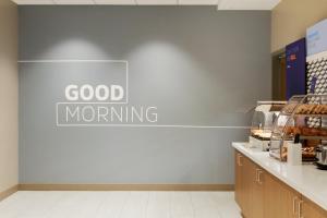a sign that reads good morning on a wall in a store at Holiday Inn Express Hotel & Suites Cleveland-Streetsboro by IHG in Streetsboro