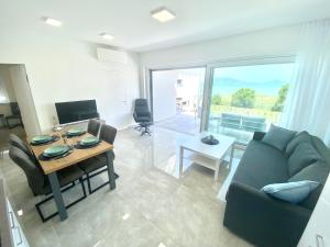a living room with a couch and a table at Villapark Apartman B2 Fonyód in Fonyód