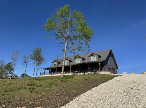 a house on top of a hill with a tree at James River Hideout in Galena