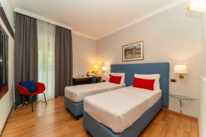 Postel nebo postele na pokoji v ubytování Hotel Royal Torino Centro Congressi