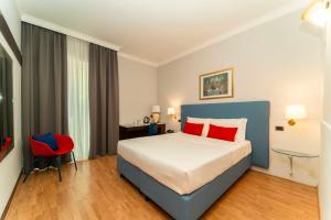 Postel nebo postele na pokoji v ubytování Hotel Royal Torino Centro Congressi