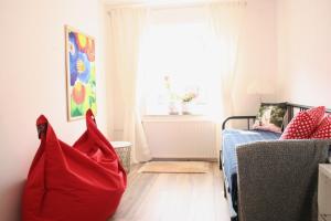 a living room with a red bag on the floor at Zollhaus 26 in Hohegeiß