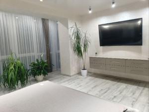 a living room with a flat screen tv on a wall at 2к шикарний люкс! in Khmelʼnytsʼkyy