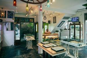 a person sitting at a table in a store at Antic Guesthouse - Galle Fort in Galle