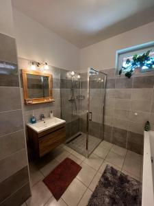 a bathroom with a shower and a sink at Vadvirág Vendégház Gárdony in Gárdony