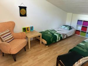 a bedroom with a bed and a chair and a table at villa de canet 66 in Canet-en-Roussillon