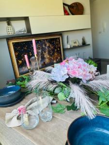 a table with two candles and flowers on it at Couple's Getaway in Is-Swieqi