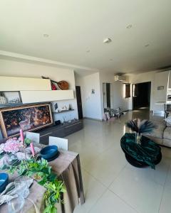 a living room with a couch and a table at Couple's Getaway in Is-Swieqi