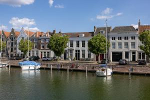 a group of boats docked at a dock on the water at Huis Delfshaven in Middelburg