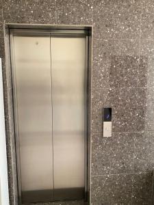 a elevator in a building with a sign on the wall at TWIGER HOUSE by WILSON in Kigali +9 photos
