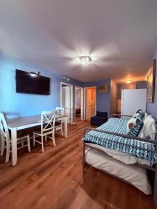 a bedroom with a bed and a table and a desk at Twilight Motel in Wildwood