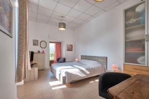 a bedroom with a bed and a table and chairs at Suite Marguerite chez l'habitant in Saint-Geoire-en-Valdaine
