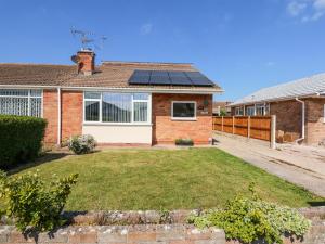 a house with solar panels on the roof at Hendre in Abergele