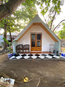 a small house with a black and white checkered floor at Kabin Sahara in Pulau Tidung-kecil