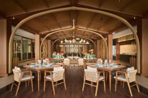 a large dining room with tables and chairs at voco Quang Binh Resort by IHG in Dong Hoi