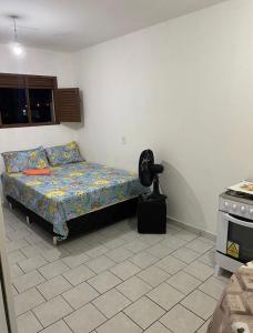 a bedroom with a bed and a stove at kitnet bem localizado in João Pessoa