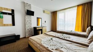 Postel nebo postele na pokoji v ubytování Hotel Eos